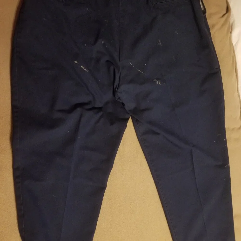 Three stained Cintas men's pants with stretching waistbands